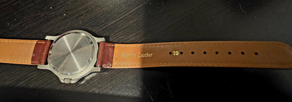 Genuine leather watch strap measuring 19 inches long shown laid flat
