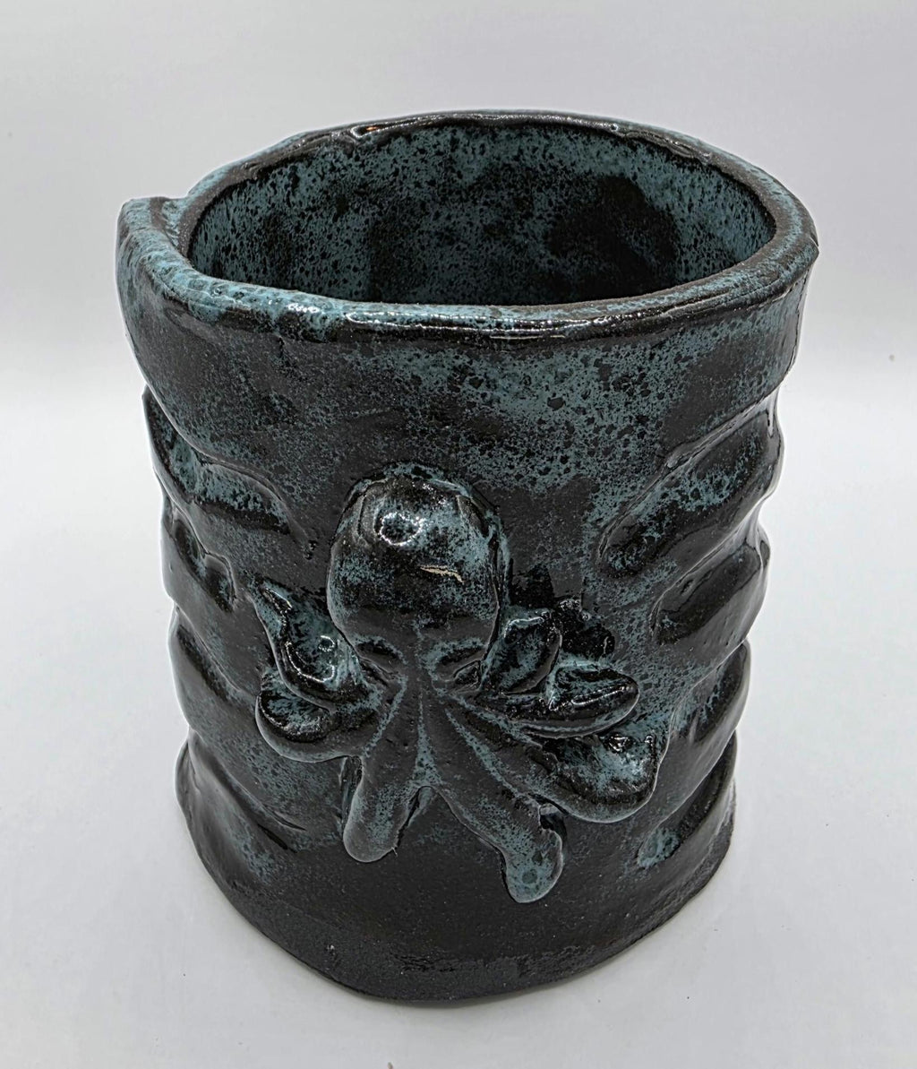 Octopus mug in black clay, handmade by Outer Reef Ceramics