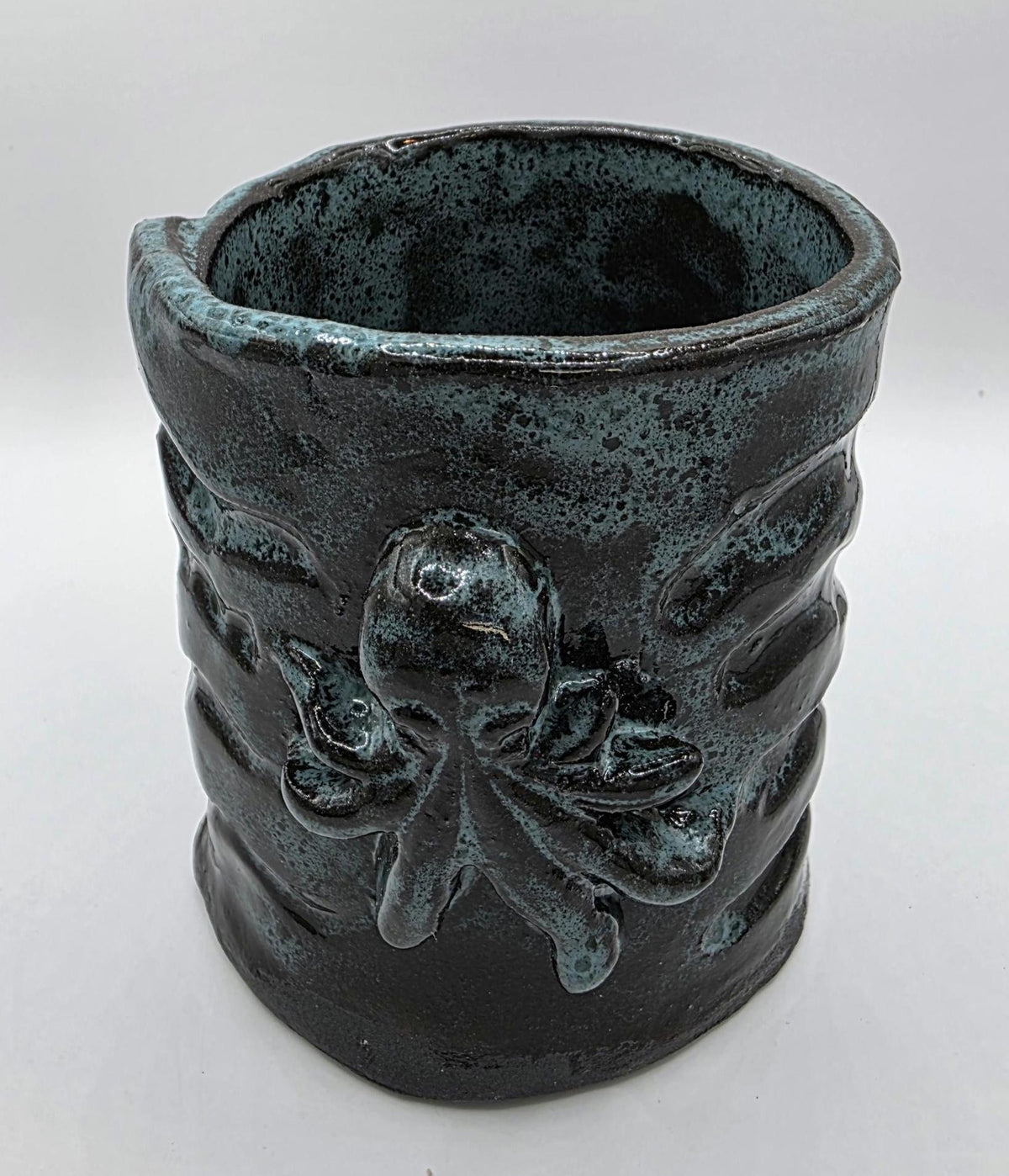 Octopus mug in black clay, handmade by Outer Reef Ceramics
