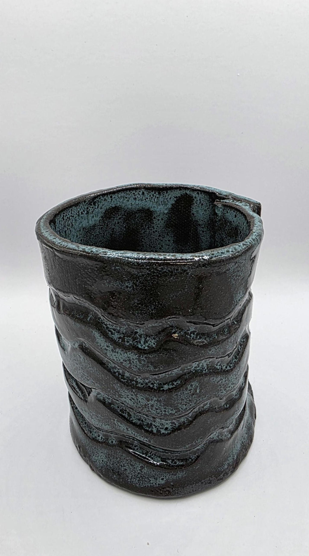 Octopus mug in black clay, handmade by Outer Reef Ceramics