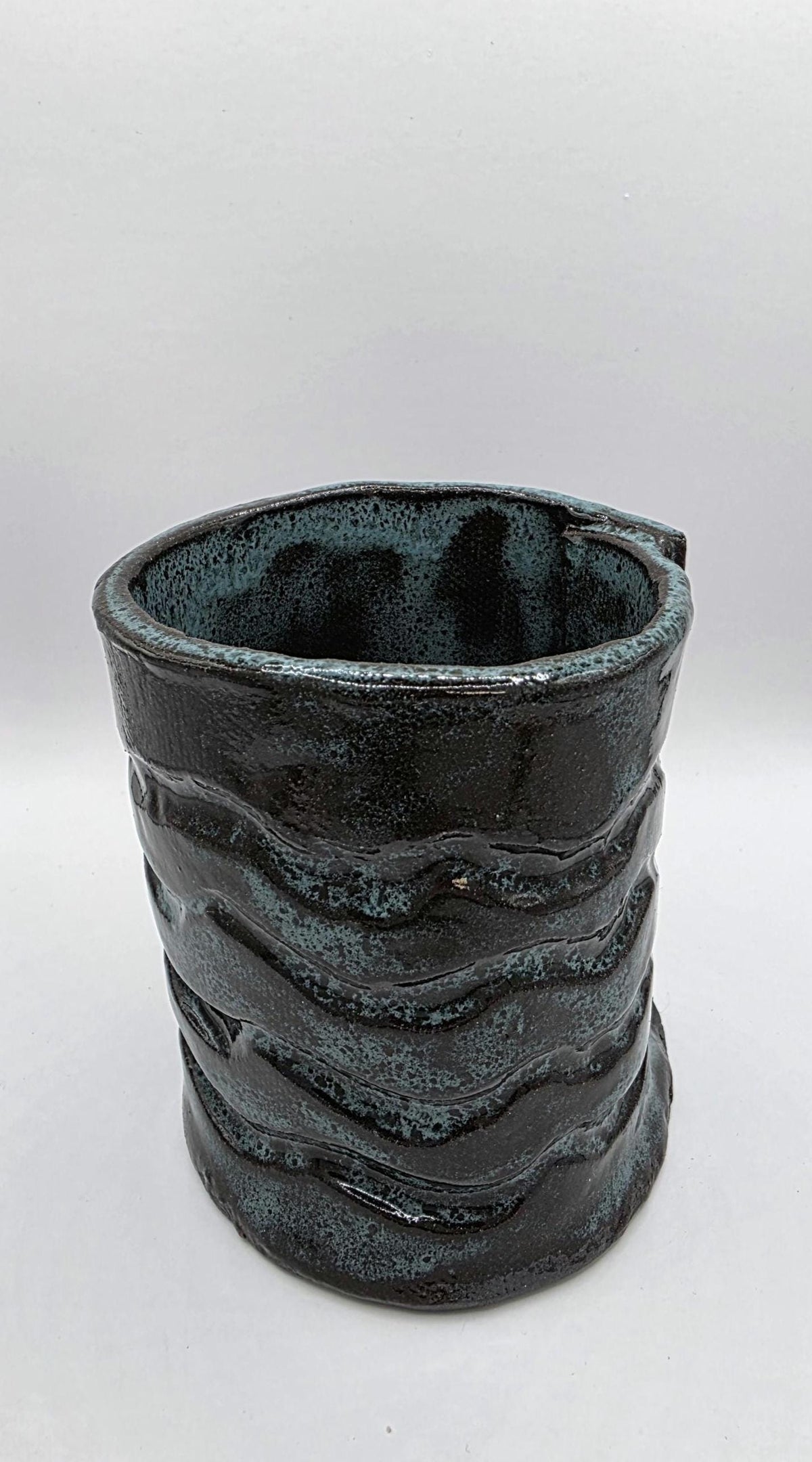 Octopus mug in black clay, handmade by Outer Reef Ceramics