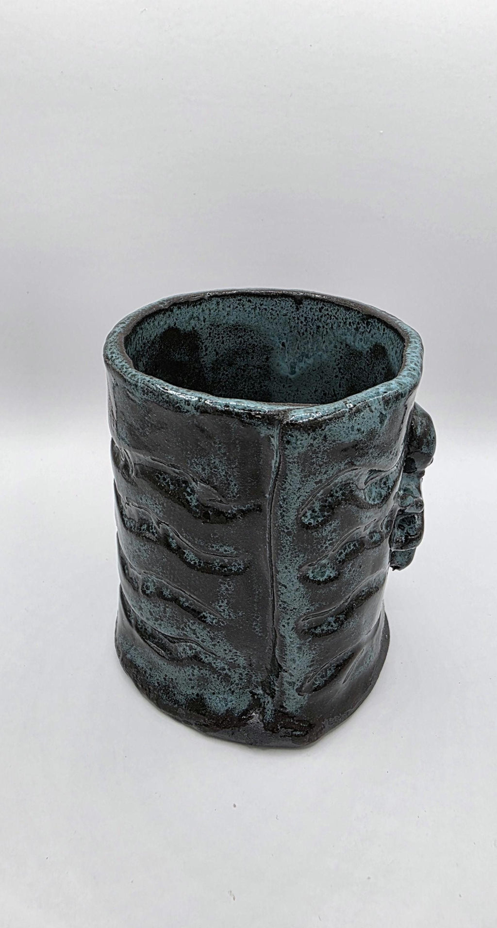 Octopus mug in black clay, handmade by Outer Reef Ceramics