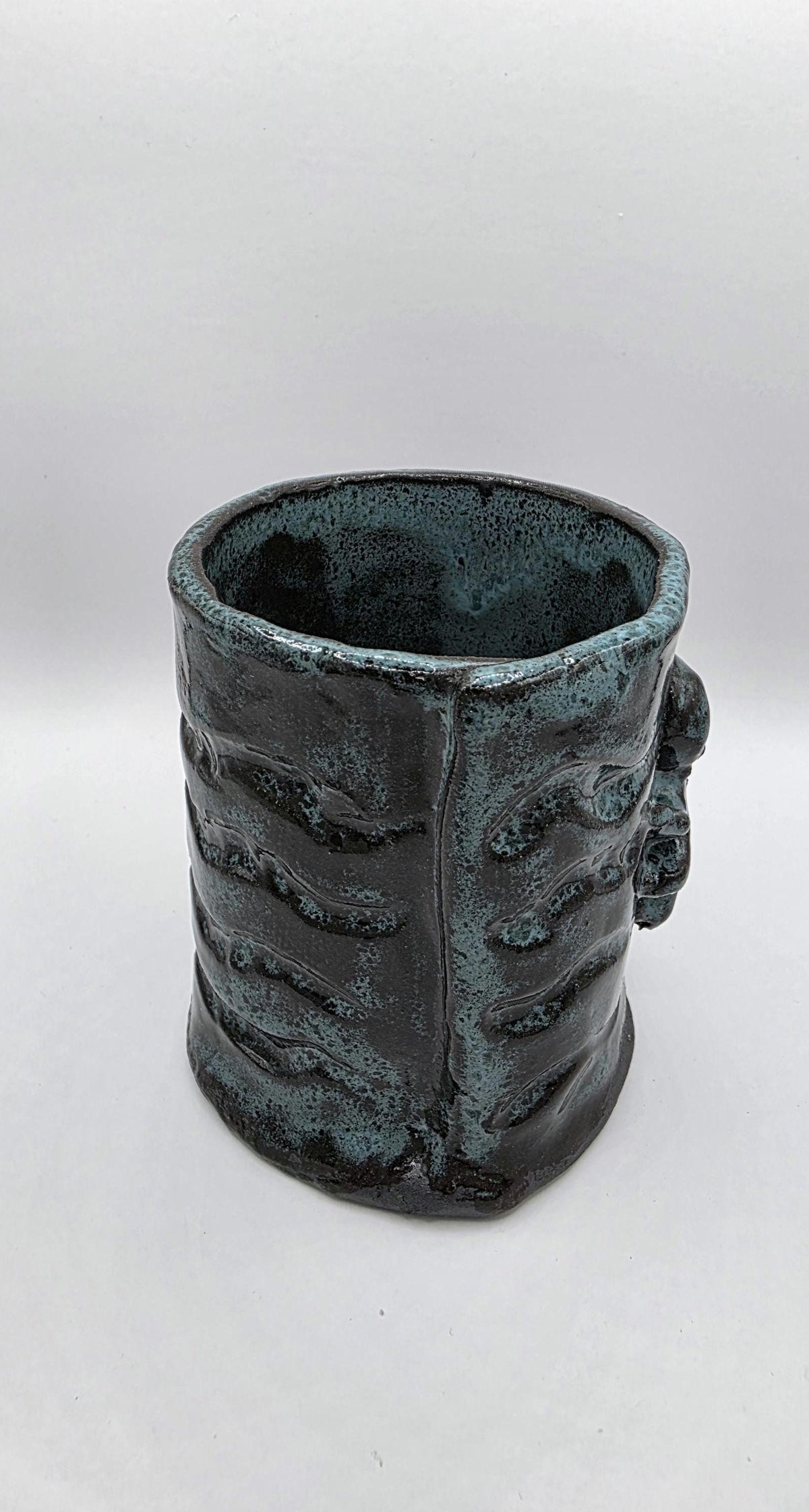 Octopus mug in black clay, handmade by Outer Reef Ceramics