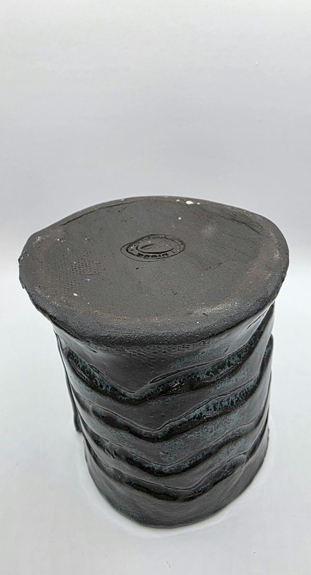 Octopus mug in black clay, handmade by Outer Reef Ceramics