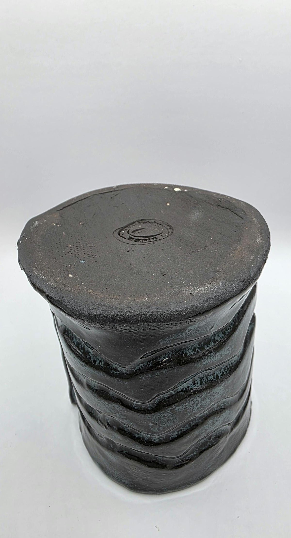 Octopus mug in black clay, handmade by Outer Reef Ceramics