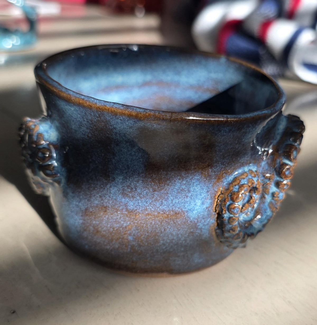 Octopus mug in black clay, handmade by Outer Reef Ceramics
