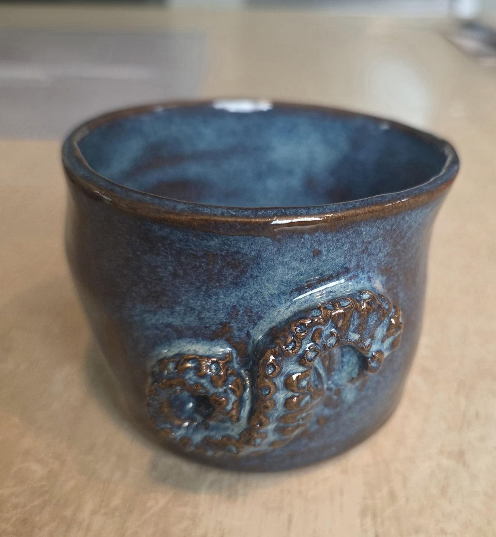 Octopus mug in black clay, handmade by Outer Reef Ceramics
